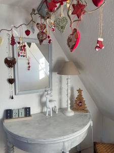 a dressing table with a mirror and christmas ornaments at Aux petits cœurs de COLMAR CENTRE WIFI in Colmar