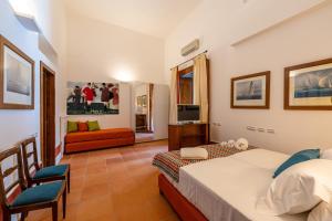 a hotel room with two beds and a television at Corte Satriano Residence in Naples