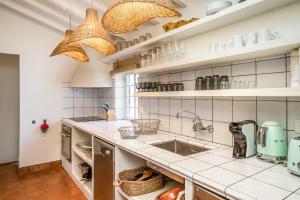 a kitchen with a sink and a counter top at Villa Torret 46 in Sant Lluis