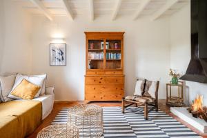 a living room with a couch and a book shelf at Villa Torret 46 in Sant Lluis