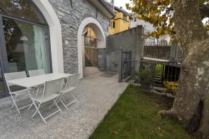 a white table and chairs on a patio at I Platani in Lezzeno