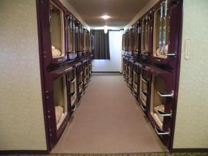 an empty room with wooden shelves in a library at ファーストイン高松 First Inn Takamatsu in Takamatsu