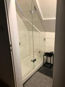 a shower with a glass door in a bathroom at Generations Holiday City Flat in Attendorn