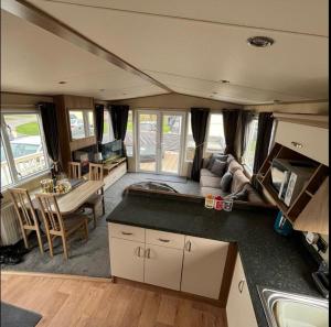 a kitchen and living room in an rv at Hot tub breaks Fairways Tattershall lakes in Tattershall