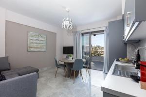 a kitchen and living room with a table and a couch at Aurora apartments in Chania Town
