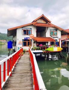 a house on a dock next to a body of water at Koi Seahouse in Ko Chang