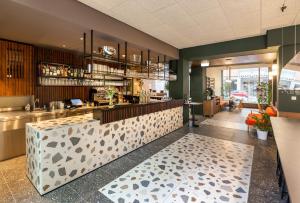 a restaurant with a counter and a bar at magdas HOTEL Vienna City - NEW OPENING AUTUMN 2022 in Vienna