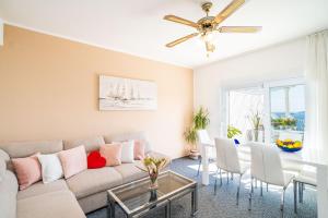 a living room with a couch and a table at Apartments Blažević in Mlini