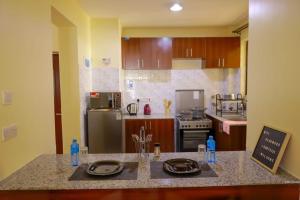 a kitchen with a counter with two plates on it at Lux Suites Greatwall Gardens Apartments in Machakos