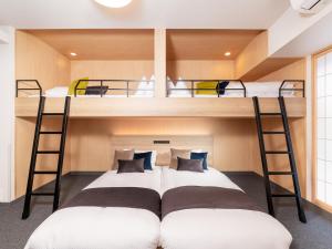 two beds in a room with two bunk beds at MIMARU OSAKA NAMBA North in Osaka