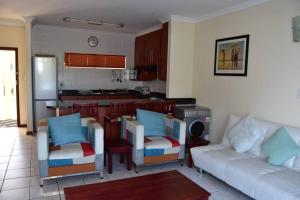 a living room with a couch and a kitchen at Apartment with Sea View at Margate, South Coast in Margate
