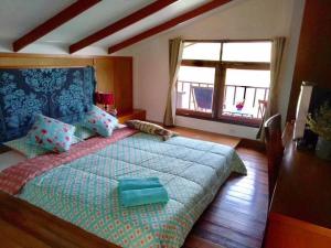 a bedroom with a large bed and a window at Koi Seahouse in Ko Chang