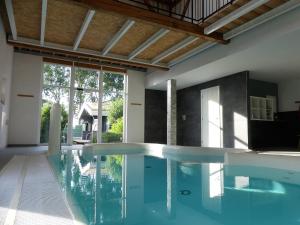 a swimming pool in a house at Het Zilte in Zuidzande