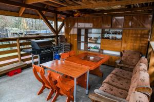 a patio with a table and chairs and a grill at Beskidzki Klimat Jaśliska in Jaśliska