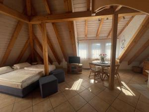 a bedroom with a bed and a table in a attic at Glattbacher Hof in Lindenfels