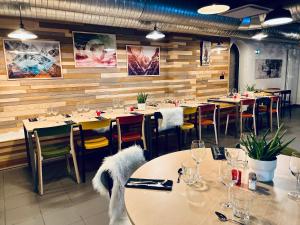 a dining room with tables and chairs and tablesktop at The People - Les 2 Alpes in Les Deux Alpes