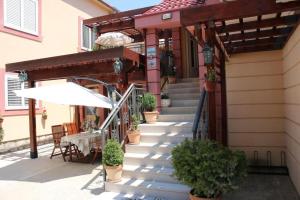 an outdoor stairway with a table and an umbrella at Apartments Dragović Nikšić in Nikšić