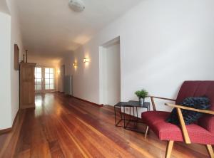 an empty living room with a red couch and a table at Haus kremsbrücke in Kremsbrücke