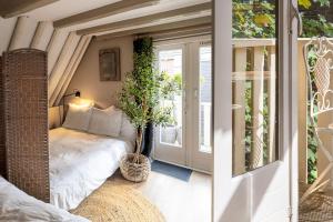 a small room with a bed and a window at Supreme City Penthouse in Leeuwarden
