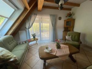 a living room with a couch and a table at Glattbacher Hof in Lindenfels