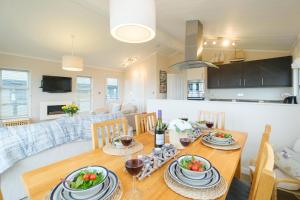 a dining room and living room with a table and chairs at San Remo in Sizewell