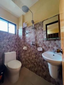 a bathroom with a toilet and a sink and a shower at CASA PRECIOSA MOALBOAL Inn in Moalboal