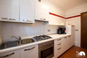 a kitchen with a sink and a stove top oven at Paraìso del Sol in Polpenazze del Garda