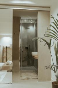 a bathroom with a shower and a sink at Four Luxury Suite in Palermo