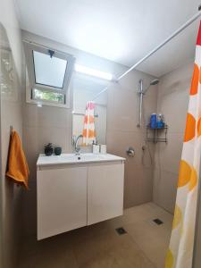 a bathroom with a sink and a shower at SAMA Tarshiha in Ma'alot Tarshiha
