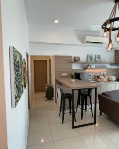 a kitchen with a table and chairs in a room at 2Bedroom Sutera Avenue Kota Kinabalu by Twen8ty Homestay in Kota Kinabalu