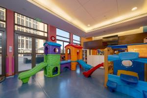 a play room with a slide and a playground at Al Gassar Resort in Doha