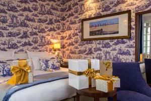 a bedroom with a bed with presents on it at Hôtel Barrière Le Normandy in Deauville