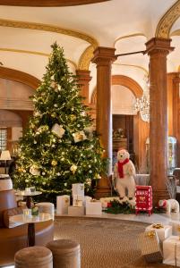 a christmas tree in a room with a teddy bear at Hôtel Barrière Le Normandy in Deauville