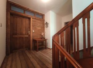 an empty hallway with a wooden door and stairs at Haus kremsbrücke in Kremsbrücke