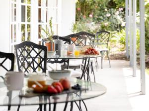 a table with fruit on it on a patio at Greyton Lodge in Greyton