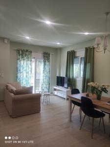 a living room with a couch and a table at Diacopto Country Houses in Diakopto