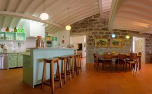a kitchen and dining room with a table and chairs at Adega do Mota in Vila Franca do Campo