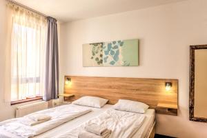 1 dormitorio con 2 camas y espejo en Central Apartments, en Budapest