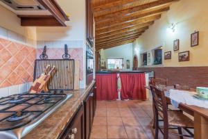 a kitchen with a stove and a counter top at Villa Gabri in Carlentini