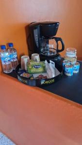 a tray of food and a coffee maker on a counter at Sunshine Apartment in Roger
