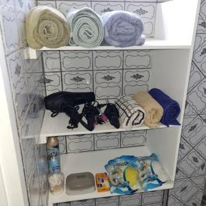 a closet filled with lots of towels and other items at Sunshine Apartment in Roger