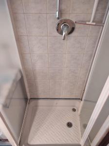 a shower with a shower head on the ceiling at Stanza Maggiore in Parma