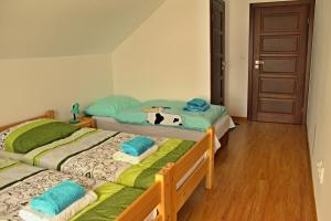 two beds in a bedroom with a cow pillow on them at Private holiday house Vivendi in Liptovský Mikuláš