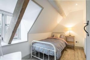 a bedroom with a bed in a attic at Park Cottage in Minchinhampton