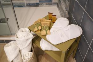 a shelf in a bathroom with towels and socks at Mediterranea Apartment- CENTRAL STATION - FREE WIFI&NETFLIX in Bari