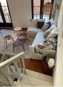 a living room with a couch and a table at The Doll’s House in Tavira