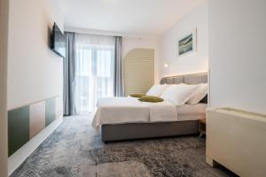 Postel nebo postele na pokoji v ubytování Hotel Nova