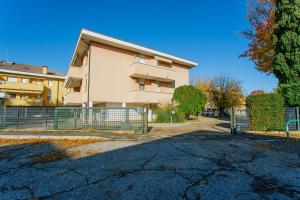 a building with a fence in front of a street at Yourbanflat Sweet Home in Padova