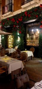 a restaurant with tables and flowers on the wall at Apartamentos Plaza,viviendas turisticas in Alicante +13 photos
