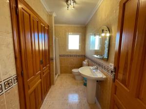 a bathroom with a sink and a toilet and a mirror at Atico Vistamar X2113 in Benitachell +50 photos